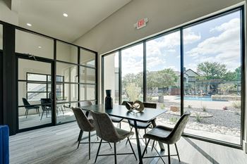 Community room with dining table and pool view